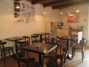 a restaurant with tables and chairs in a room at B&B Lo Straniero in Rivello