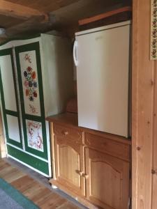 a kitchen with a refrigerator and a cupboard at Obere Roner Kasa in Mörtschach