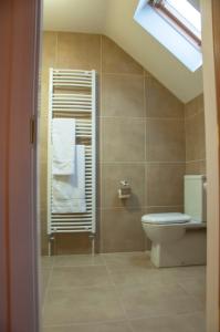 a bathroom with a toilet and a towel at Finn Cottage in Strabane +29 photos