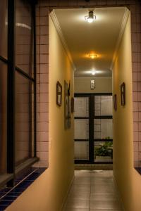 a hallway in a building with a window at Requinte Hotel in Sao Paulo