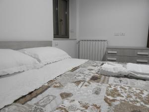 a bedroom with a bed with a quilt on it at Soggiorno "Ulivi" in Altino