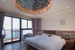 Postel nebo postele na pokoji v ubytování So Lohas B&B