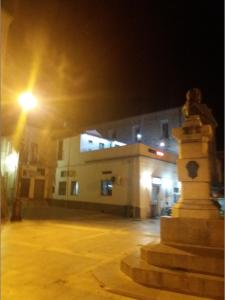 una estatua delante de un edificio por la noche en Bar Centrale Zichella, en Lacedonia