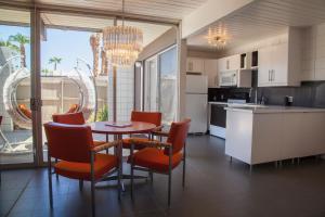 a kitchen with a table and chairs and a dining room at Ocotillo Lodge in Palm Springs