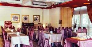 una sala de conferencias con mesas, sillas y un piano en Yago Inn, en Tamsui