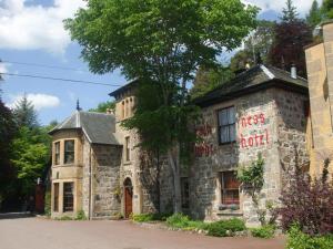 an old stone building with a kings hotel sign on it at Loch Ness Lodge Hotel in Drumnadrochit