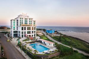 a hotel with a swimming pool next to the ocean at Muong Thanh Holiday Ly Son in Ly Son