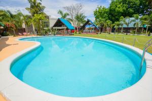 a large swimming pool with blue water at Balai Carmela in Tuguegarao City