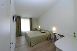 Postel nebo postele na pokoji v ubytování Aromi Piccolo Hotel