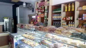 a display case in a bakery with lots of pastries at Pearl Beach Bungalow in Alleppey