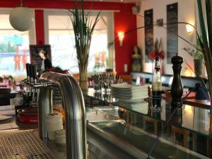 a kitchen with a sink and a counter with plates at Hotel Berlin in Schwetzingen