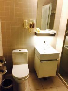 a bathroom with a toilet and a sink at Jinjiang Inn Select Shanghai International Tourist Resort Chuansha Subway Station in Shanghai