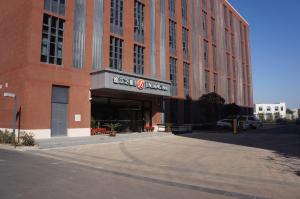 a large red brick building with a sign on it at Jinjiang Inn Select Shanghai International Tourist Resort Chuansha Subway Station in Shanghai