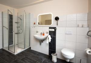 a bathroom with a sink and a toilet and a shower at Hotel Jägerhof in Staatsbad Brückenau