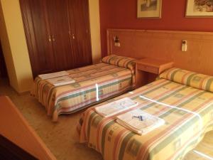 Postel nebo postele na pokoji v ubytování Hostal Carlos III