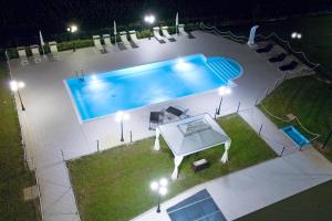 una vista panoramica su una piscina di notte di Hotel Marconi a Bentivoglio