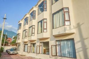 a building with large windows on the side of it at Ganpati Hotel Katra in Katra