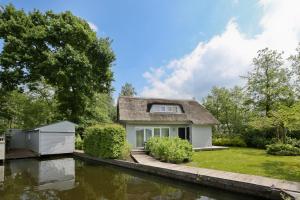 a house in the middle of a river at Idyllic Lakehouse - dog is welcome fenced garden in Haren