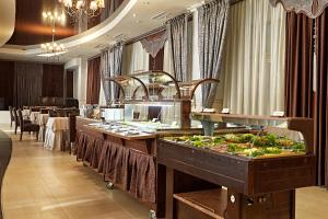 a restaurant with a buffet line with food on display at Hotel Lviv in Lviv