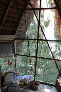 una ventana en una cabaña con una mesa y un tazón de comida en Reserva Natural Tanimboca, en Leticia