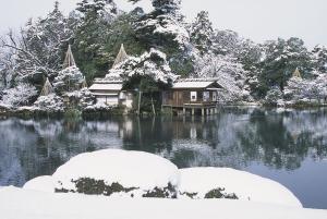 a house in the middle of a lake in the snow at Vacational Rental Sunny Heights in Kanazawa
