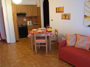 a kitchen with a table and chairs and a couch at Villa San Marco- via Carducci in Grado