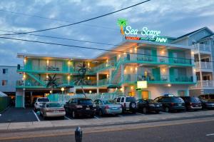 a large building with cars parked in front of it at Sea Scape Inn in Wildwood Crest