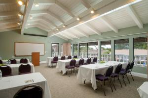 a conference room with tables and chairs and a whiteboard at Lighthouse Lodge & Cottages in Pacific Grove +28 photos