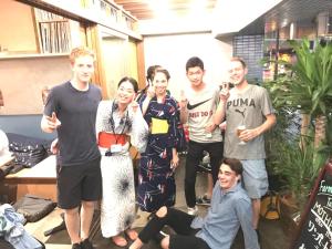 a group of people posing for a picture at Wise Owl Hostels Shibuya in Tokyo