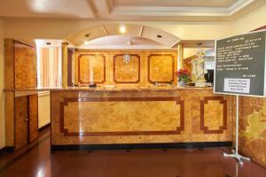 a kitchen with a counter and a sign in a room at Hotel Swan Inn in Pune