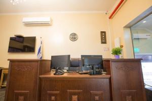 an office with a desk with two computers on it at Central Laguardia Hotel in Tel Aviv