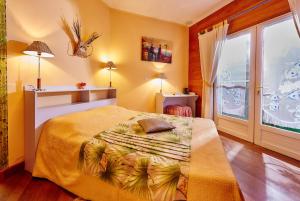 a bedroom with a bed and a large window at Pinpin D'amour in Basse Vallée +39 photos
