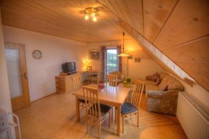 a living room with a table and a couch at Ferienwohnungen Lindleshof in Leinach