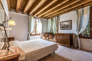 Posteľ alebo postele v izbe v ubytovaní Casa Contarini