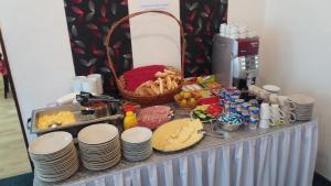 a buffet with plates and food on a table at Hotel Pyramida in Brno