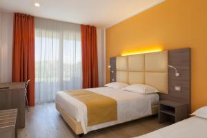 Postel nebo postele na pokoji v ubytování Hotel Bella Lazise