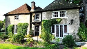 an old house with ivy on the front of it at Chalk Farm LDC in Eastbourne