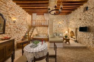 a room with a table and chairs in a building at Rodia House in Lardos