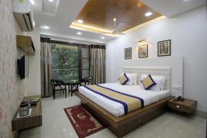 a hotel room with a bed and a table at Gazebo Inn & Suites Medanta in Gurgaon
