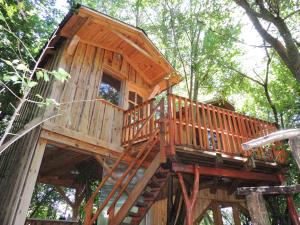a large wooden tree house in the woods at Kerca Bio Farm in Kercaszomor