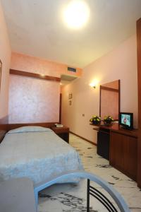 Postel nebo postele na pokoji v ubytování Hotel Excelsior