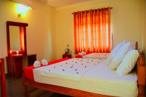 a bedroom with a large bed and a mirror at Mount View in Polonnaruwa