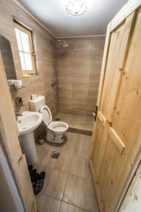 a bathroom with a toilet and a sink at Gradačka Banja brvnare in Gradac +38 photos
