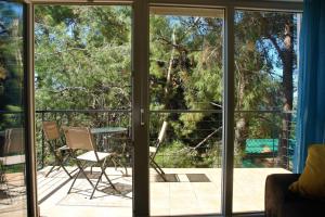a room with sliding glass doors looking out onto a patio at Quercus Apartment in Stara Baška