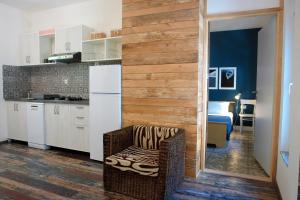 a kitchen with a white refrigerator and a chair at Quercus Apartment in Stara Baška