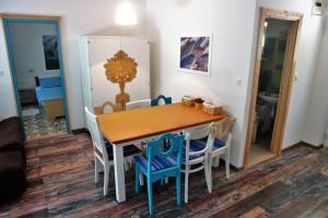 a dining room with a wooden table and chairs at Quercus Apartment in Stara Baška