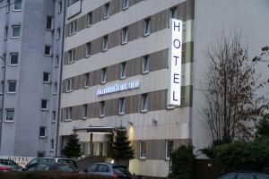 a building with a hotel sign on the side of it at Hotel Niederräder Hof in Frankfurt/Main