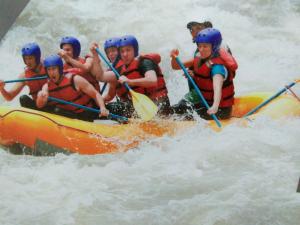a group of people in a raft in the water at Niwasa House in Hatton