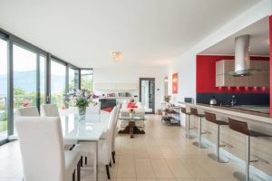 a kitchen and dining room with a white table and chairs at Parco San Andrea Elegante in Menaggio