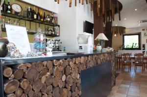 a bar in a restaurant with wooden logs on the counter at B&B La Timpa Del Cucco in Roccagloriosa